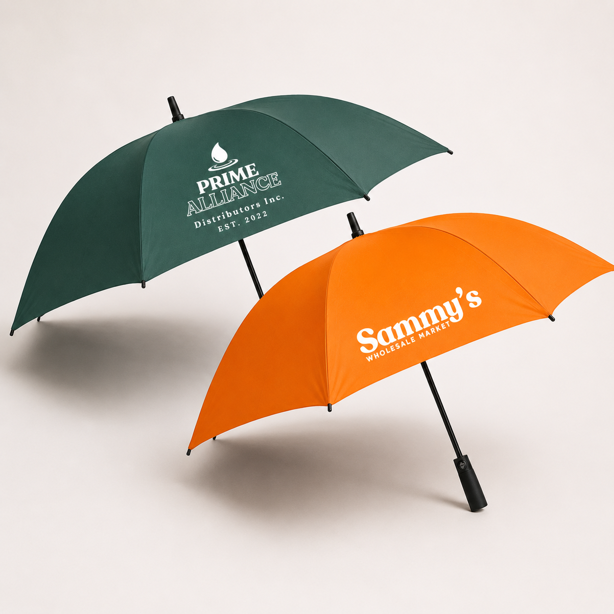 Two branded golf umbrellas on a studio background