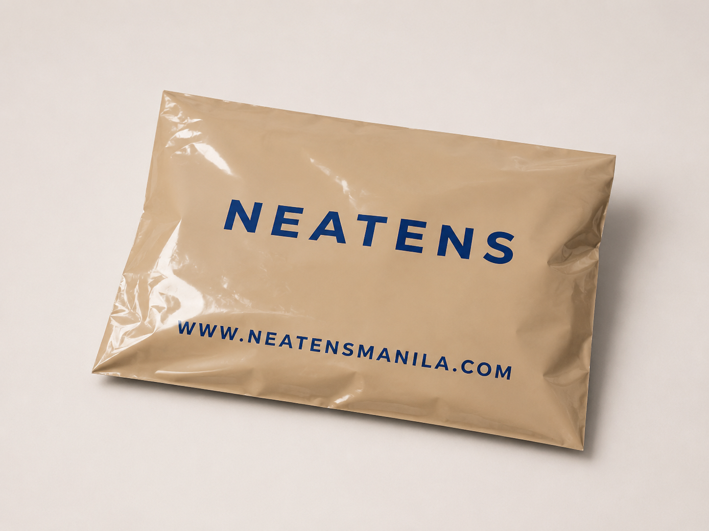 Brown plastic mailer bag on a studio surface