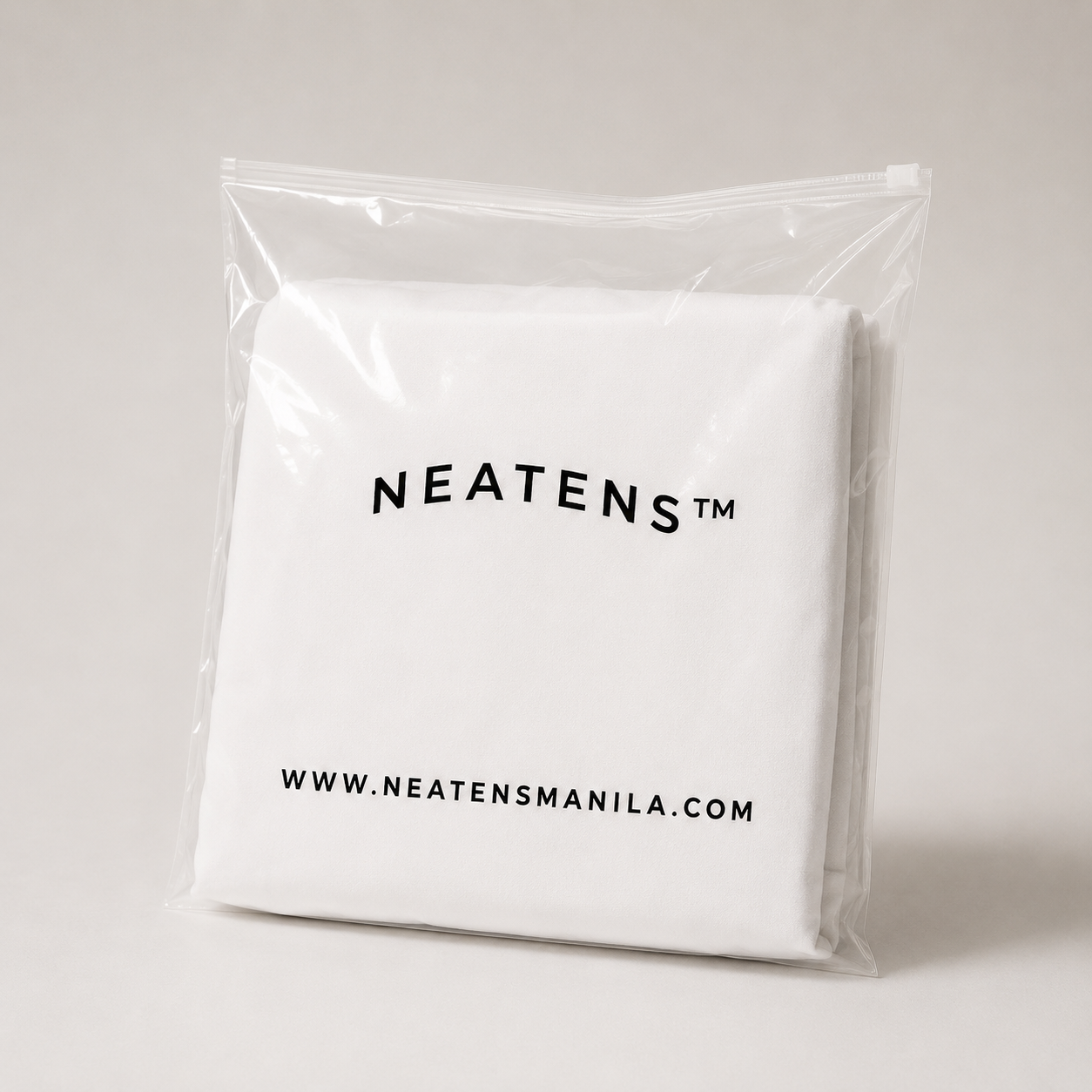 Clear ziplock bag containing a folded white fabric product